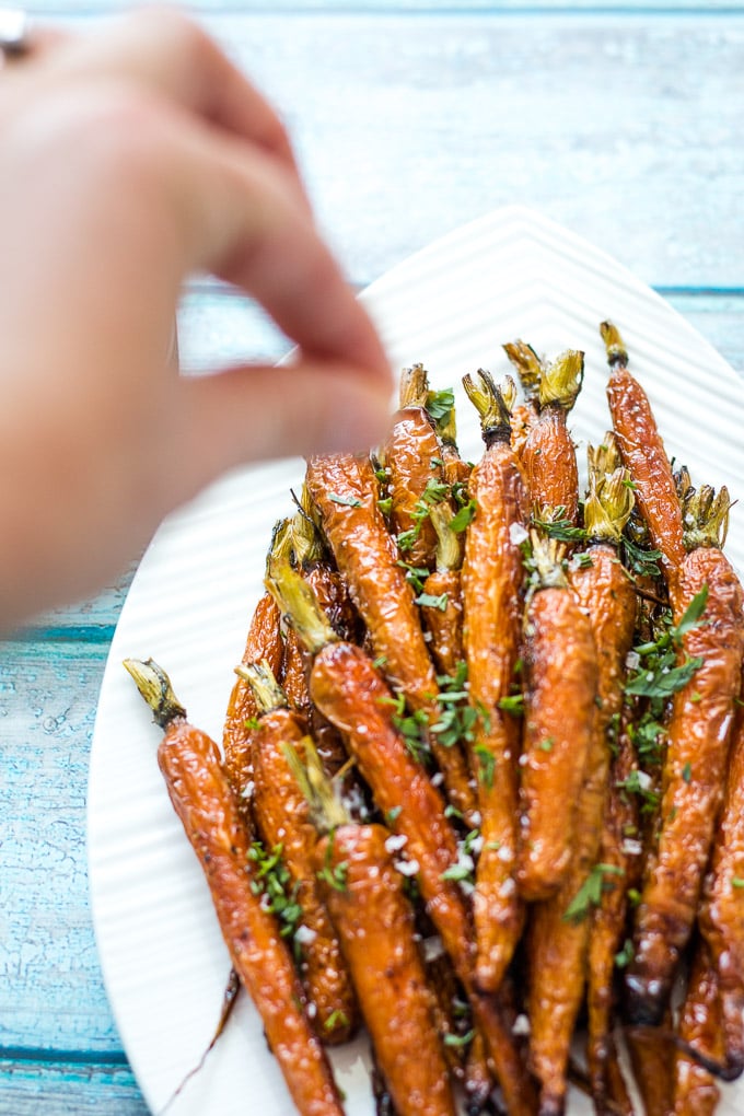 sprinkling salt on Dutch Carrots