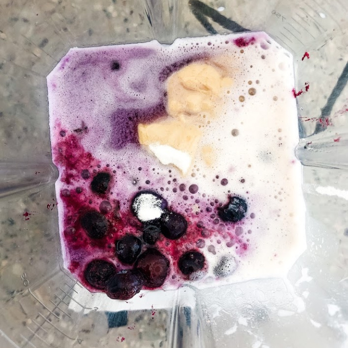 ingredients for blueberry almond milk smoothie in a blender