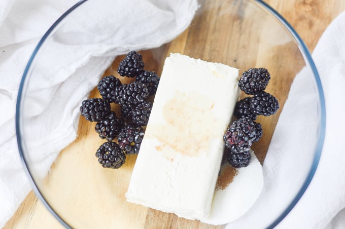 cream cheese and blackberries in a bowl