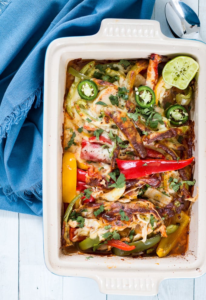 healthy chicken fajita casserole in a blue le creuset casserole dish