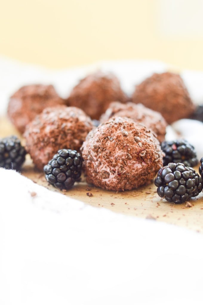 dark chocolate blackberry cheesecake balls stacked high