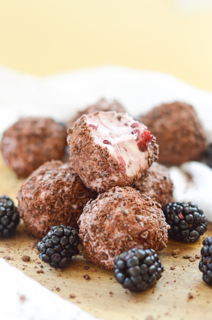 Bliss ball without dates: dark chocolate blackberry cheesecake balls stacked high