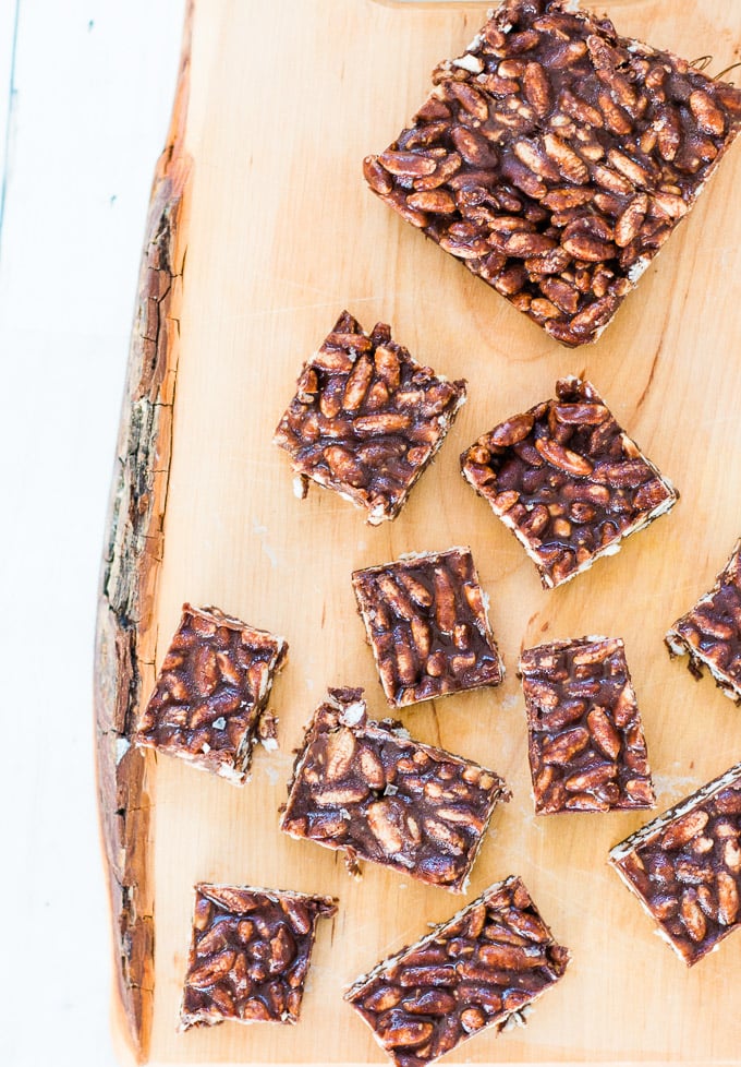 peanut butter and chocolate rice bubble slice cut into slices on a wooden board