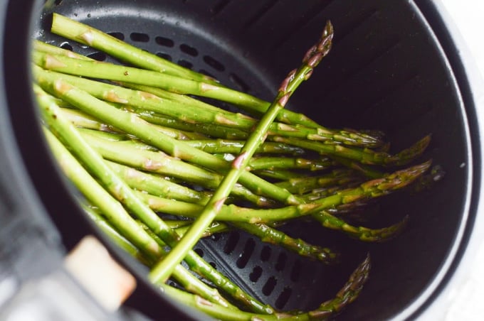 Asparagus in the tray of an air fryer