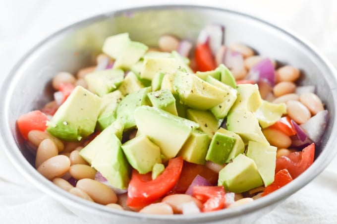 Add the avocado to the mixture for the white bean salad