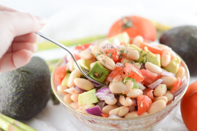 Avocado salad being eaten from the bowl with a fork