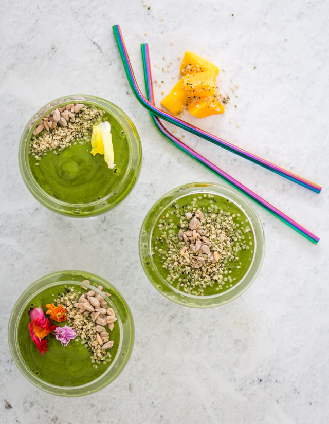 Mango Banana Smoothies in glasses surrounded by multicoloured straws