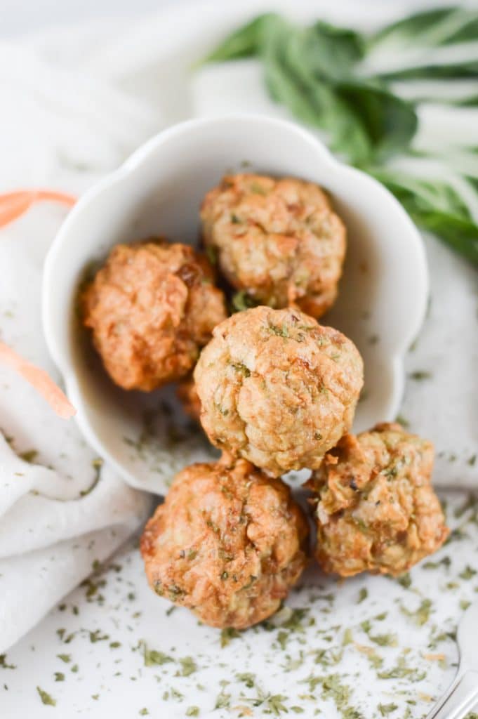 5 air fryer meatballs in a white serving bowl