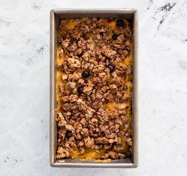 Top the pumpkin and apple bread batter with the granola