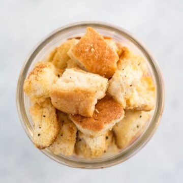 overhead shot of a glass jar containing croutons