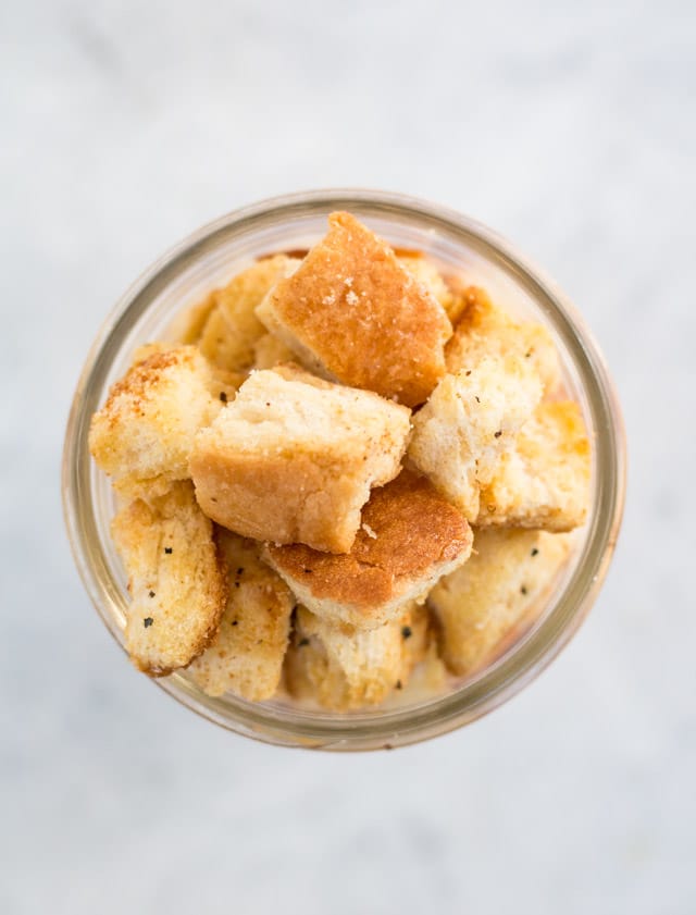 overhead shot of a glass jar containing croutons