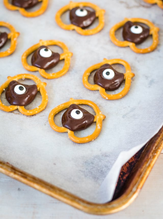 a baking tray with baking paper and cooling halloween pretzel bites