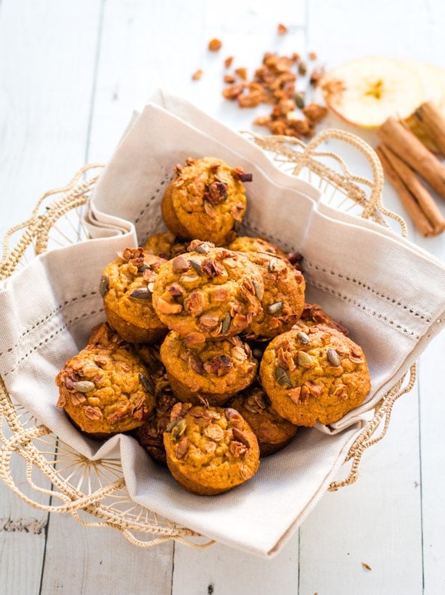 Mini muffins in a straw basket with a linen napkin