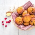 Basket full of sweet cranberry cornbread muffins