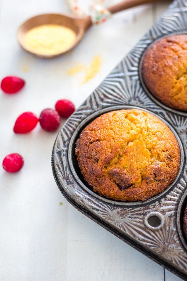 Up close shot of Cranberry and Honey Cornbread Muffins in a vintage muffin tin