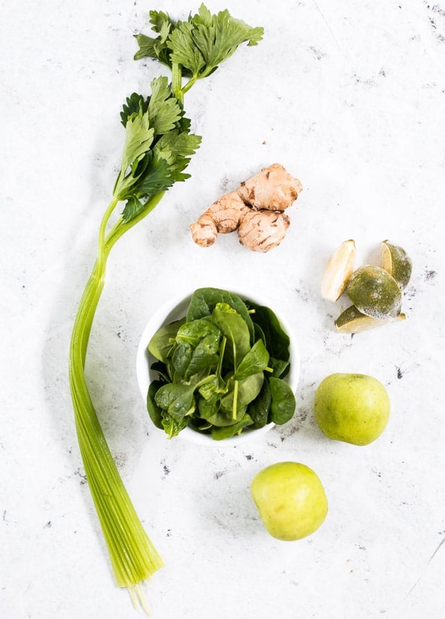 ingredients to make a celery smoothie: celery, apple, spinach, ginger and lime