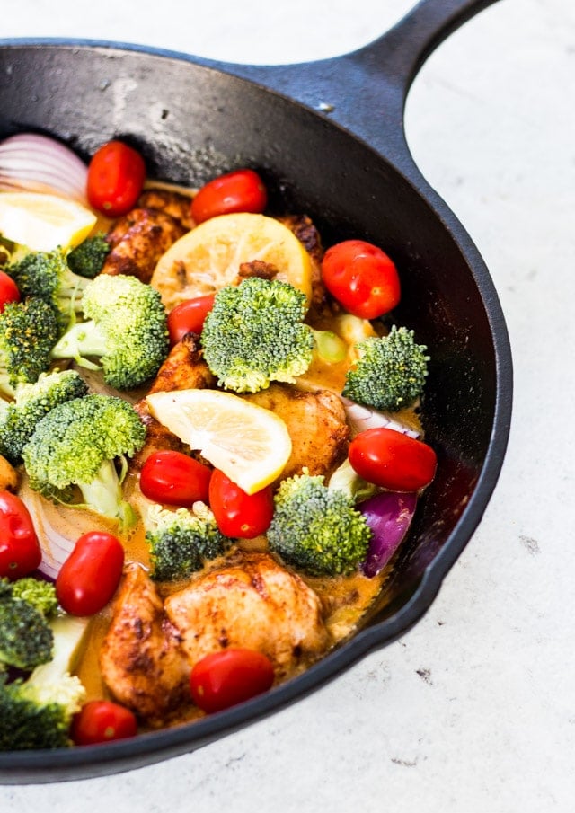 Uncooked vegetables in a pan with the lemon garlic butter chicken