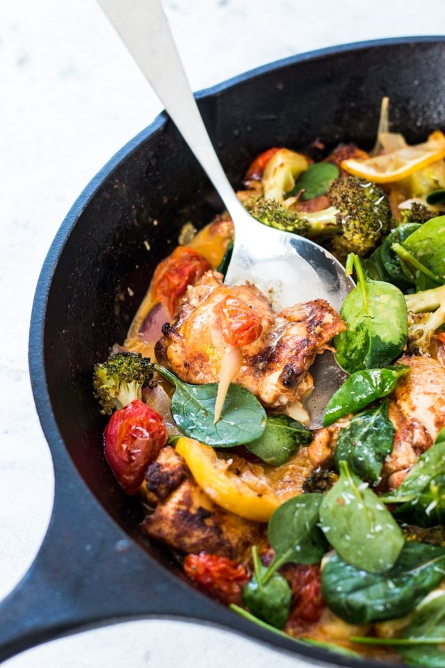 Up close shot of Garlic butter chicken with veggies in a large black cast iron skillet