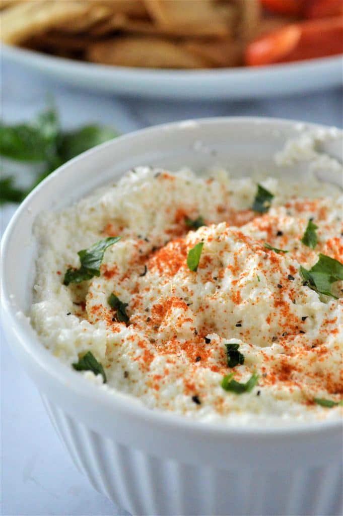 close up shot of Whipped Feta Dip in a small white ramekin