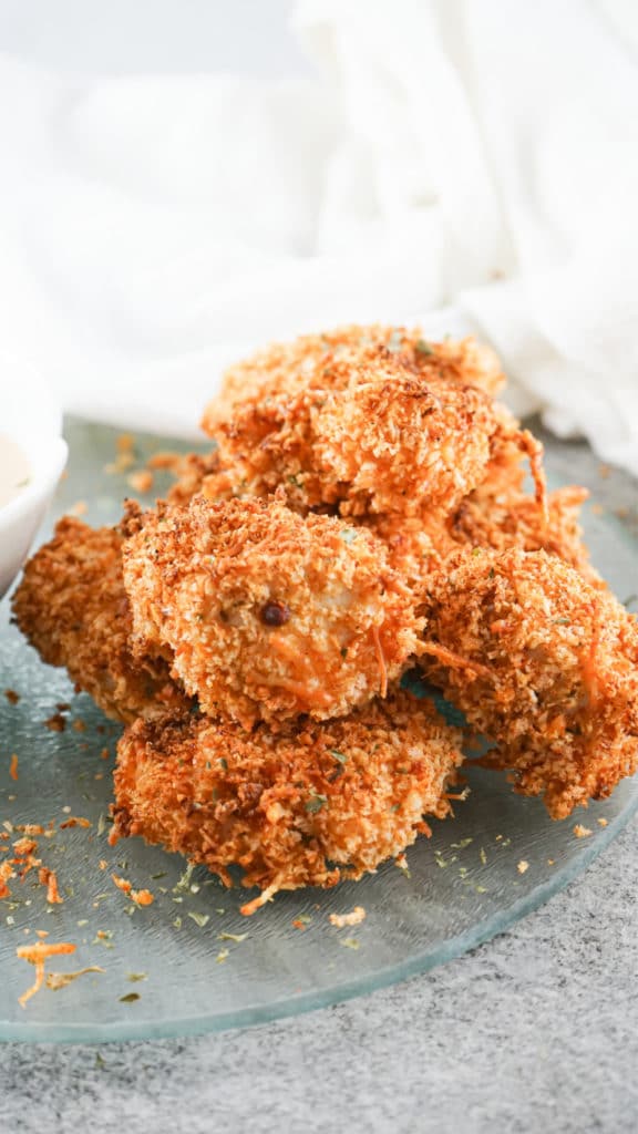 Up close shot of Air Fryer Chicken Nuggets piled onto a glass serving dish