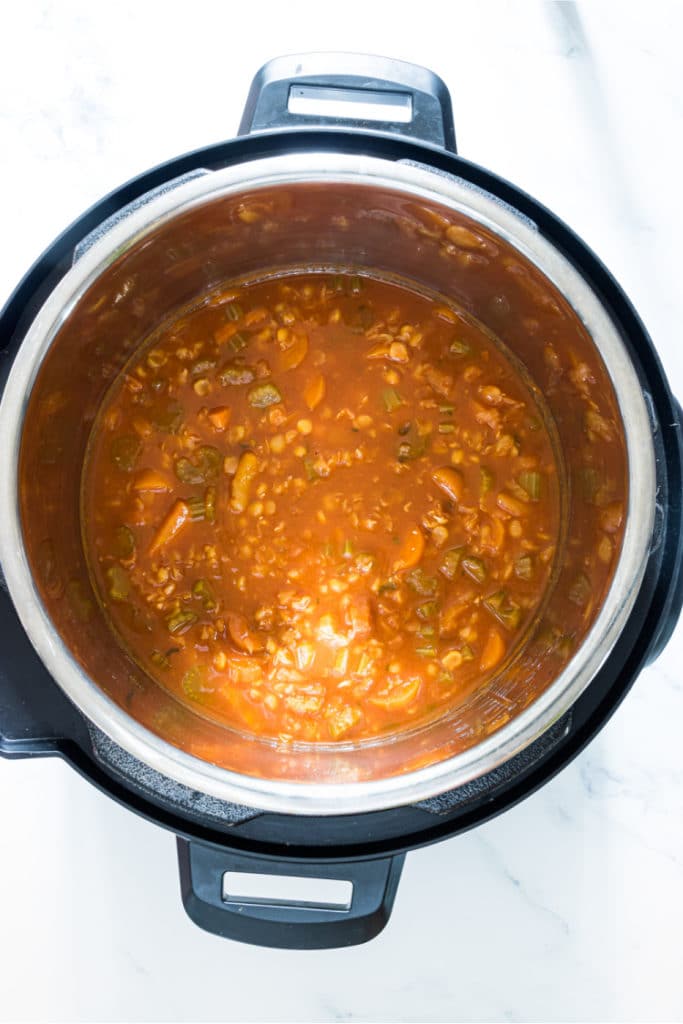 Instant pot filled with all of the ingredients for a split pea soup