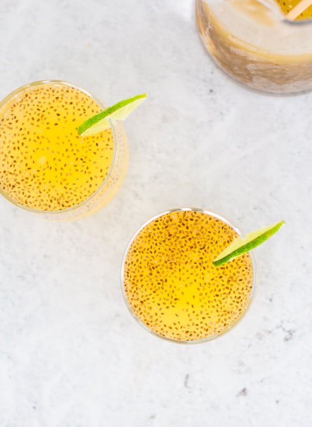 Pineapple chia water served in two glasses with a slice of lime on the side