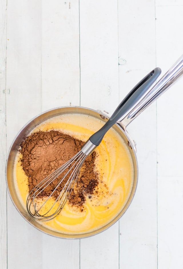 Cacao and maple syrup added to steamed cream: step 2 in making homemade chocolate sauce