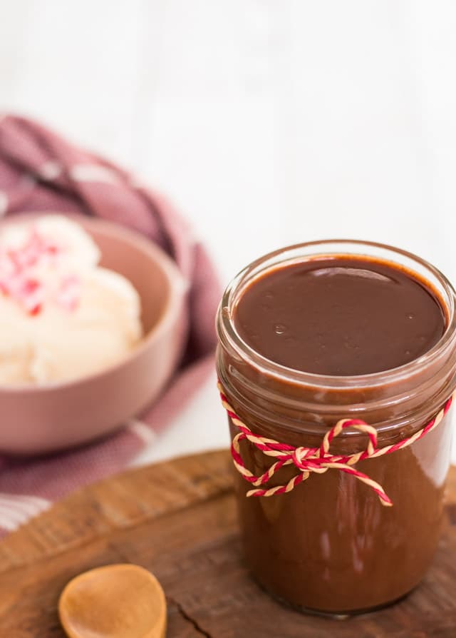 A glass jar containing cooled peppermint creamer