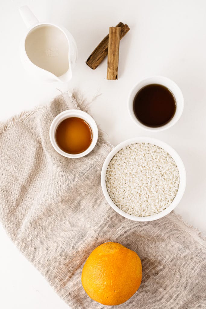 Overhead ingredient shot of what is needed to make almond milk rice pudding