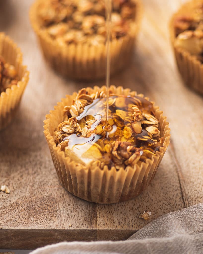 A drizzle of maple syrup on top of a apple cinnamon muffin