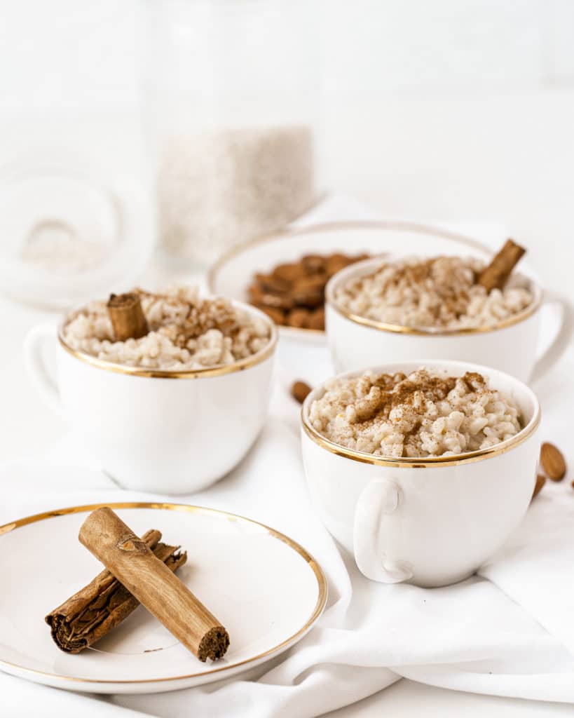 Easy rice pudding served in white and gold tea cups