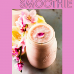 pineapple grapefruit smoothie served in a glass mason jar with pineapple and pink flowers in the background