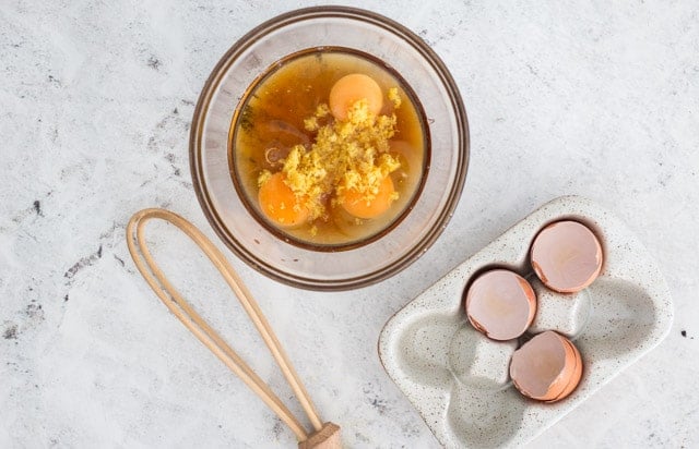 Overhead shot of ingredients for lemon curd being mixed together