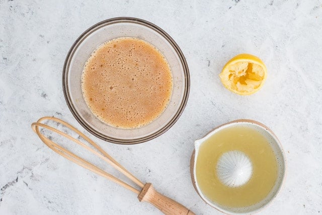 Overhead shot of ingredients for lemon curd being mixed together