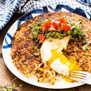 potato rosti topped with a poached eggs and a fresh tomato salsa