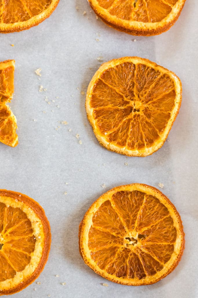 Baking sheet holding dehydrated orange slices