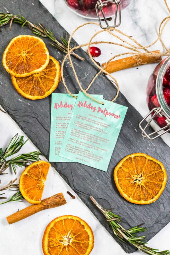 gift tag instructions against a slate tray surrounded by dehydrated oranges