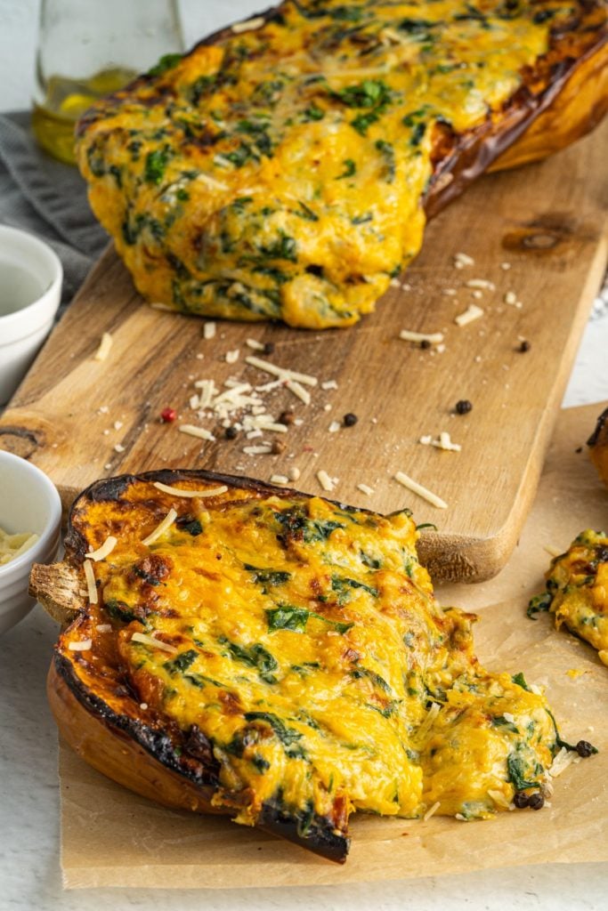 Frontal shot of vegetarian stuffed squash served on a wooden board