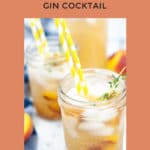 overhead shot of a fresh peach and honey cocktail served in a glass mason jar with some yellow polkadot straws