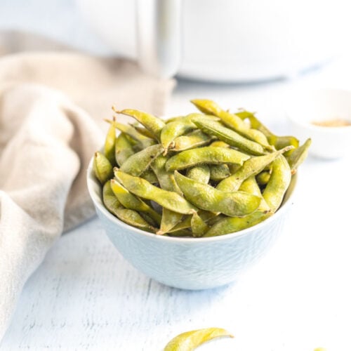 Sesame Edamame served in a small off-white bowl