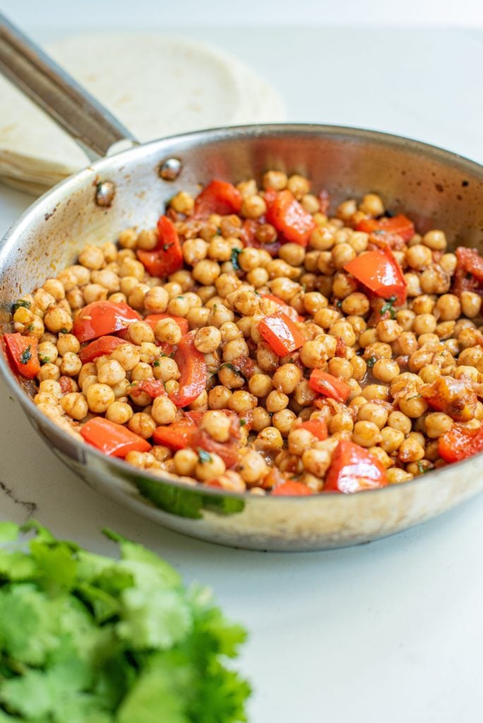 Spiced bell pepper and chickpea mixture in a large saucepan