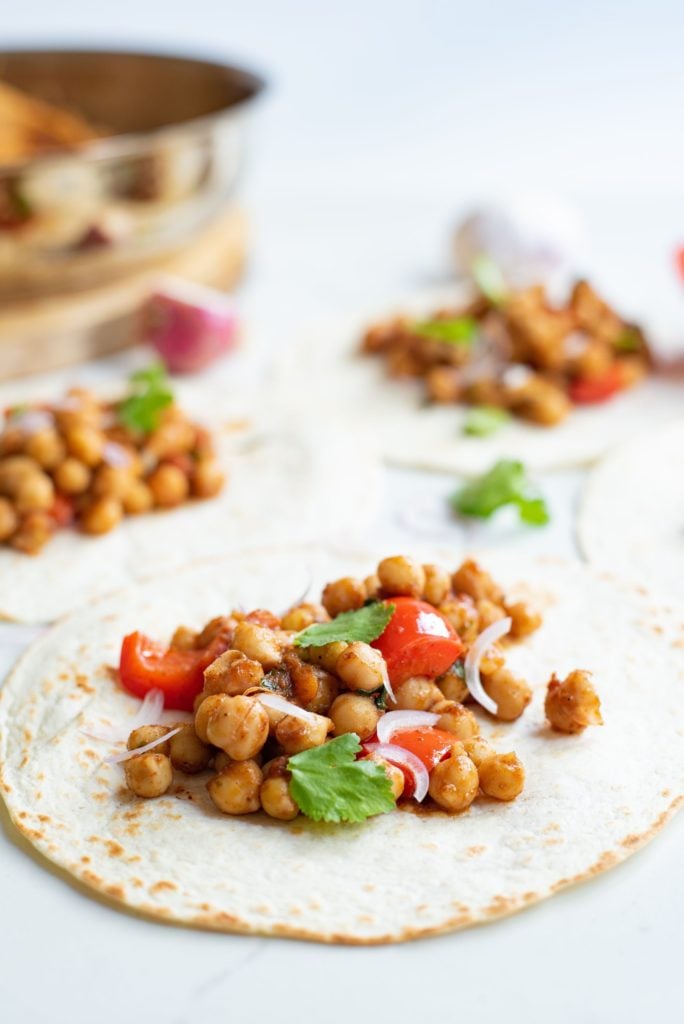 Chickpea and bell pepper taco filling divvied up into a flour tortilla and served with some fresh cilantro