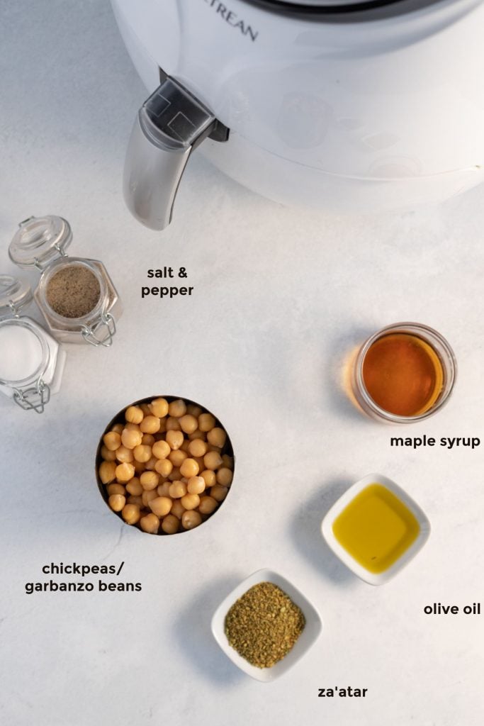 overhead labelled ingredient shot of chickpeas, zaatar, maple syrup, olive oil and salt and pepper.