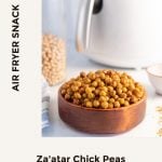 pin featuring zaatar chickpeas served in a wooden bowl with a white air fryer in the background