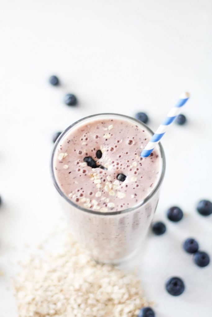 smoothie or milkshake in a tall glass with a straw