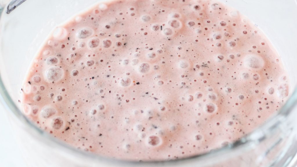 a pink/purple smoothie blended with a few bubbles on top