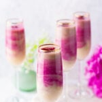 Layered smoothie served in 4 tall skinny glasses