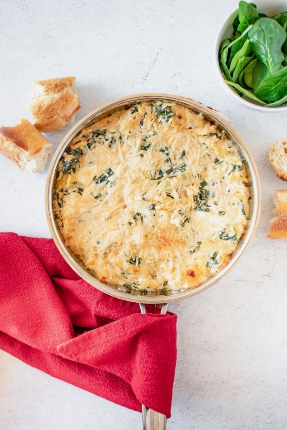 crockpot spinach artichoke dip without mayo added to a saucepan and broiled until the cheese on top is brown and bubbly