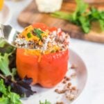 A spoonful of cauliflower rice and lentils from a red bell pepper