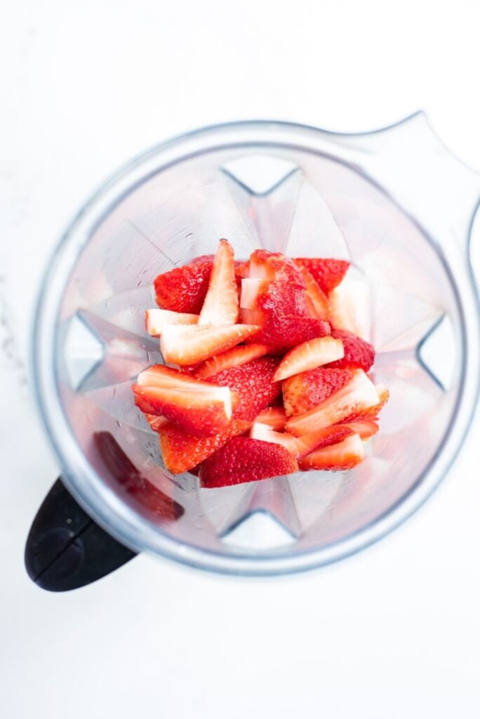 overhead shot of strawberries in a blender jug